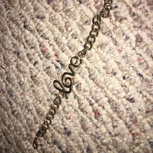 “love” gold bracelet